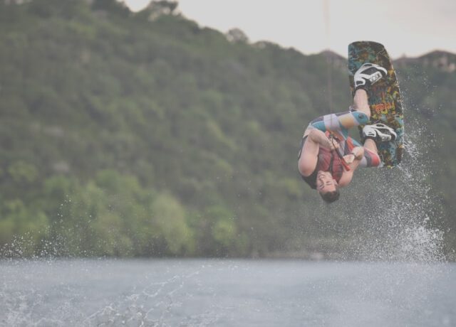 man jumps on wakeboard